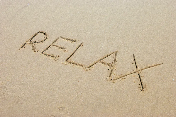 stock image Relax handwritten inscription in sand on a beach