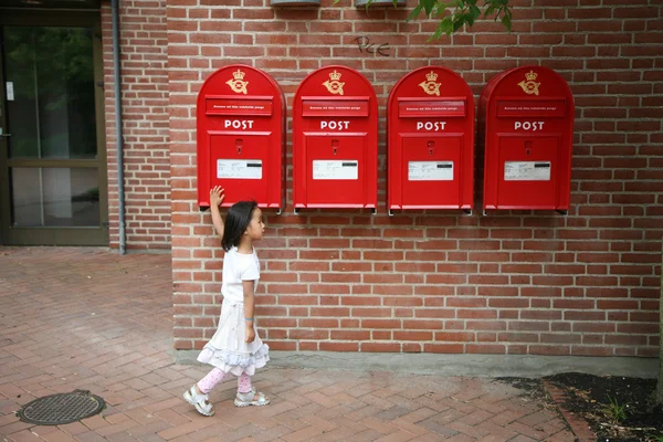 Girl and postboxes — Stock Photo, Image