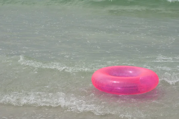 Pink Life Saver in Ocean Surf — Stock Photo, Image