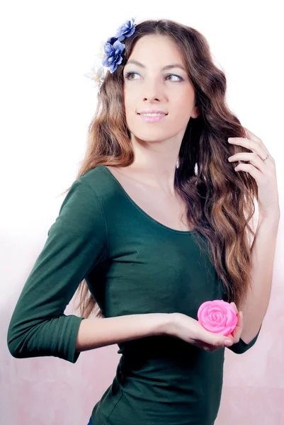 Young beautiful woman with flowers in hair and hands — Stock Photo, Image