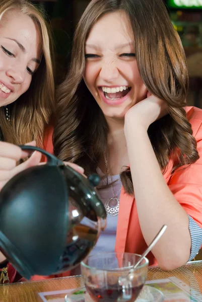 Smiling girls drinking tea — Stock Photo, Image