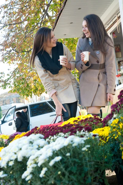 To vakre unge jenter som kjøper blomster. – stockfoto