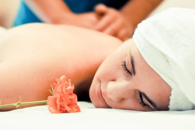 Young woman having massage treatment clipart