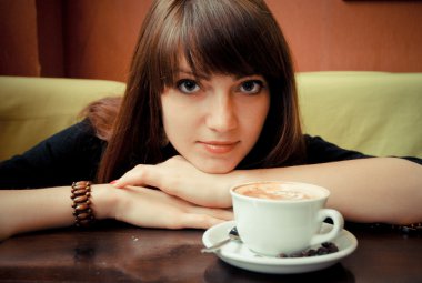 Young girl with a cup of coffee clipart