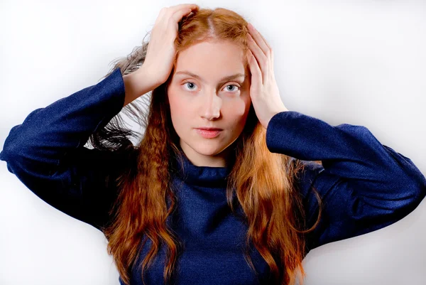 Young redhaired woman holding her head — Stock Photo, Image