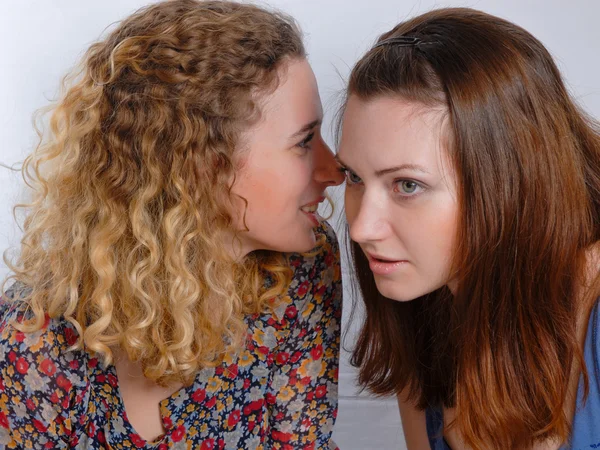 Two girl friends sharing a secret — Stock Photo, Image