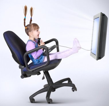 Child girl playing computer game clipart