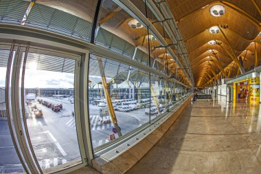 Passengers walk by at the new terminal T4 at Barajas airport clipart