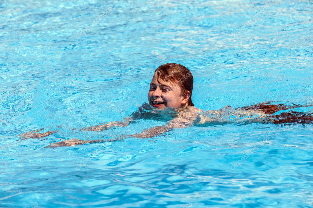 Boy swimming in the pool Stock Photo by ©Hackman 10091744