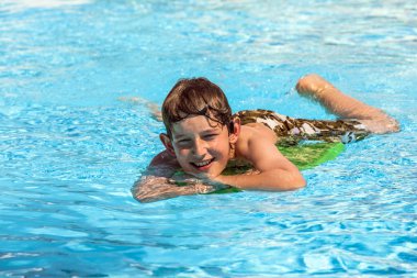 Boy in the pool relaxing