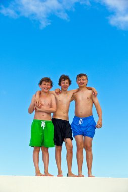 Three friends in swimmware stick together clipart