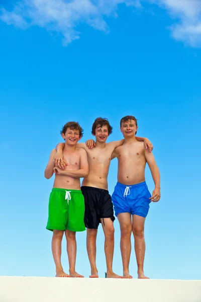 Three friends in swimmware stick together — Stock Photo, Image
