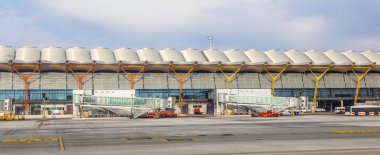 MADRID, SPAIN - APRIL 1: Aircrafts park at Terminal 4 at Barajay clipart