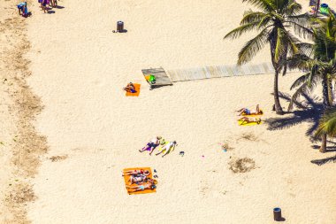 Beach with tourists in summer in Arrecife clipart