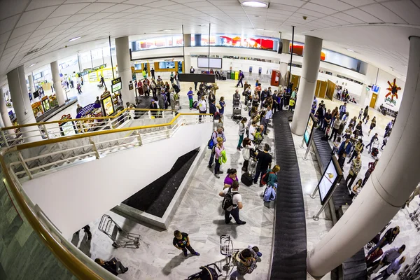 Turistas esperan su equipaje en el aeropuerto —  Fotos de Stock