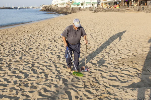 stock image Government man cleans the beach