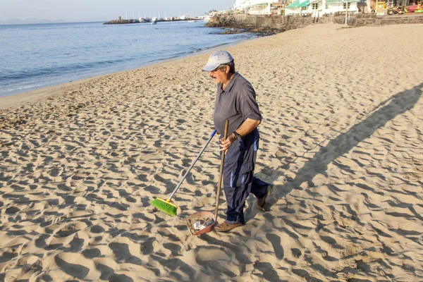 stock image Government man cleans the beach