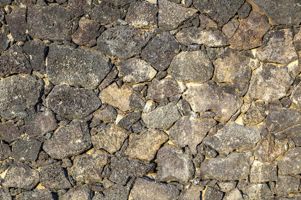 Pared hecha sin costuras de piedra volcánica —  Fotos de Stock