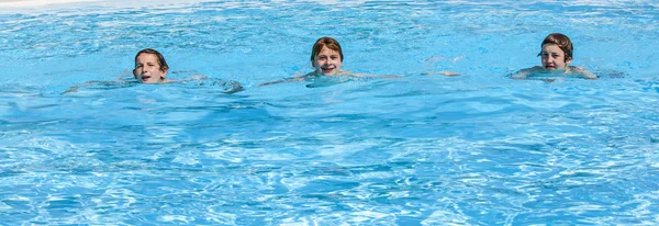 Три мальчика плавают в бассейне — стоковое фото