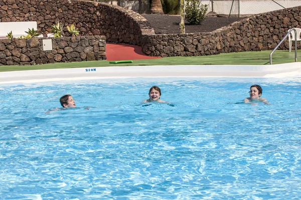 Tre ragazzi che nuotano in piscina — Foto Stock