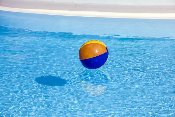 Uppblåst plastboll som flyger i poolen — Stockfoto