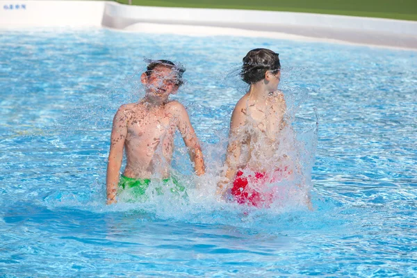 Broers samenspelen in het zwembad — Stockfoto