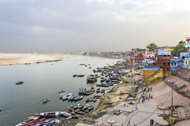 Colorful main ghat in varanasi with boats clipart