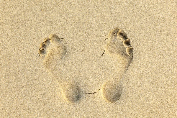 Людські сліди в піску на пляжі — стокове фото