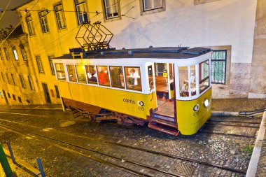 Lisbon at night, famous tram, historic streetcar is running clipart