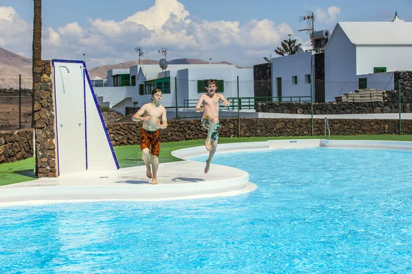 Dos amigos saltando en la piscina —  Fotos de Stock