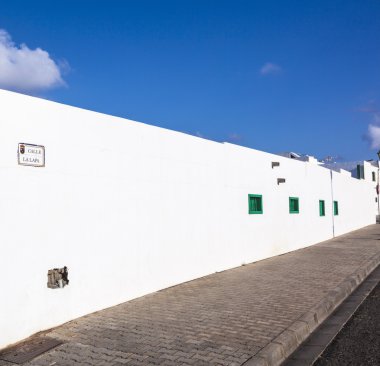 Facade f mediterranean house with closed shutterblinds