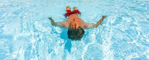 Hombre atractivo disfruta nadando en la piscina — Foto de Stock