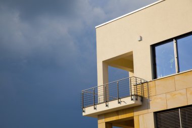 Balcony of modern flat with dark clouds in rain clipart