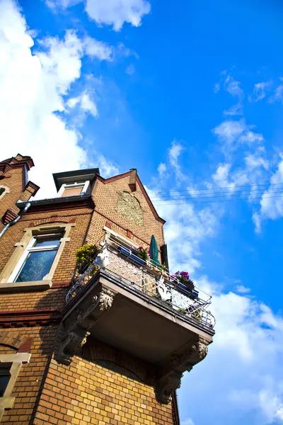 Balcony of old brick house with blue sky — Stock Photo, Image