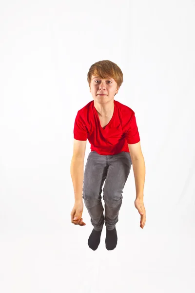 Happy boy with red shirt jumping — Stock Photo, Image