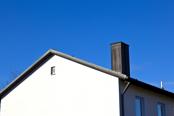 Generic family home in suburban area with blue sky