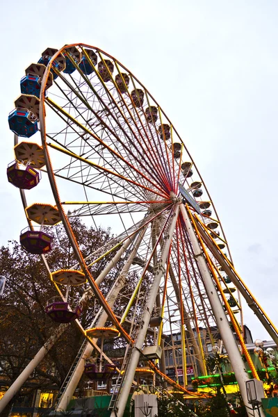 Big wheel in motion with dark clouds