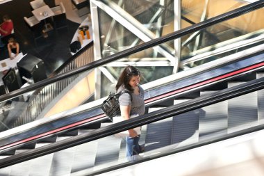 on a staircase in modern shopping center in Frankfurt clipart