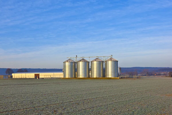 stock image Silos in the middle of a field in wintertime