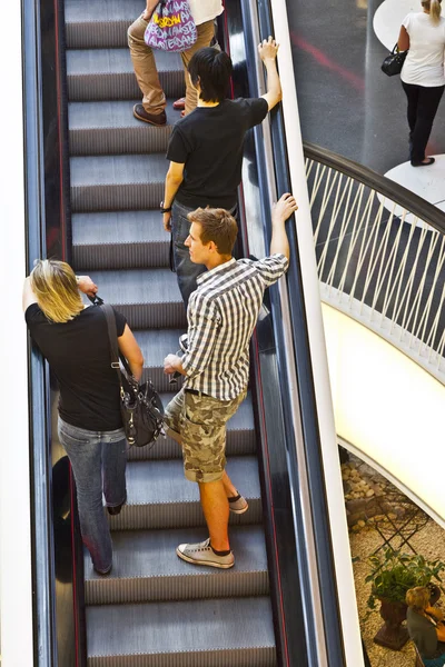 On a moving staircase in modern shopping center in Frankfurt — Stock Photo, Image