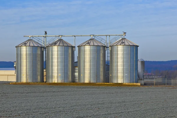 Silos in the middle of a field in wintertime Stock Photo
