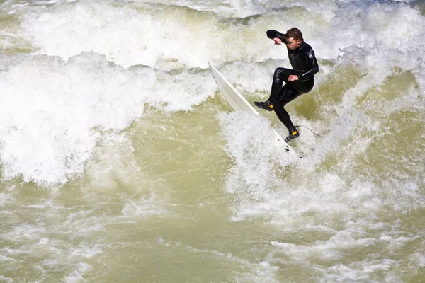 Surfing on river ISAR in Munich, Germany. Stock Image