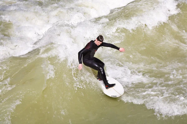 Surfing on river ISAR in Munich, Germany. Royalty Free Stock Photos