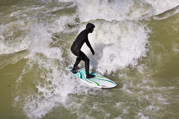 Surfing on river ISAR in Munich, Germany. Royalty Free Stock Images