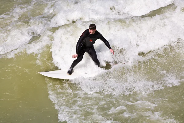 Surfing on river ISAR in Munich, Germany. Royalty Free Stock Photos