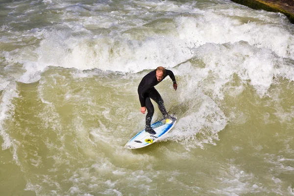 Surfing on river ISAR in Munich, Germany. Stock Photo