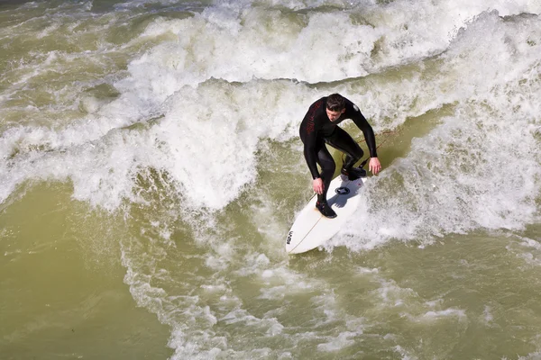 Surfing on river ISAR in Munich, Germany. Stock Picture