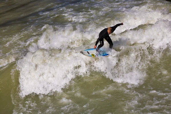 Surfing on river ISAR in Munich, Germany. Stock Image