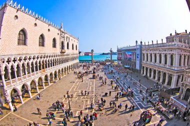 Tourists on San Marco square feed large flock of pigeons clipart