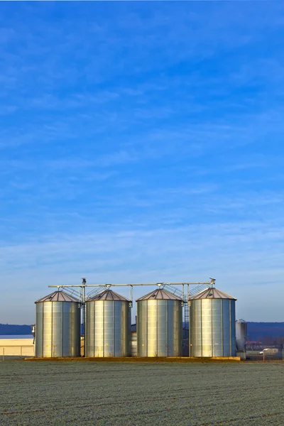Silos in the middle of a field in wintertime — Stock Photo, Image